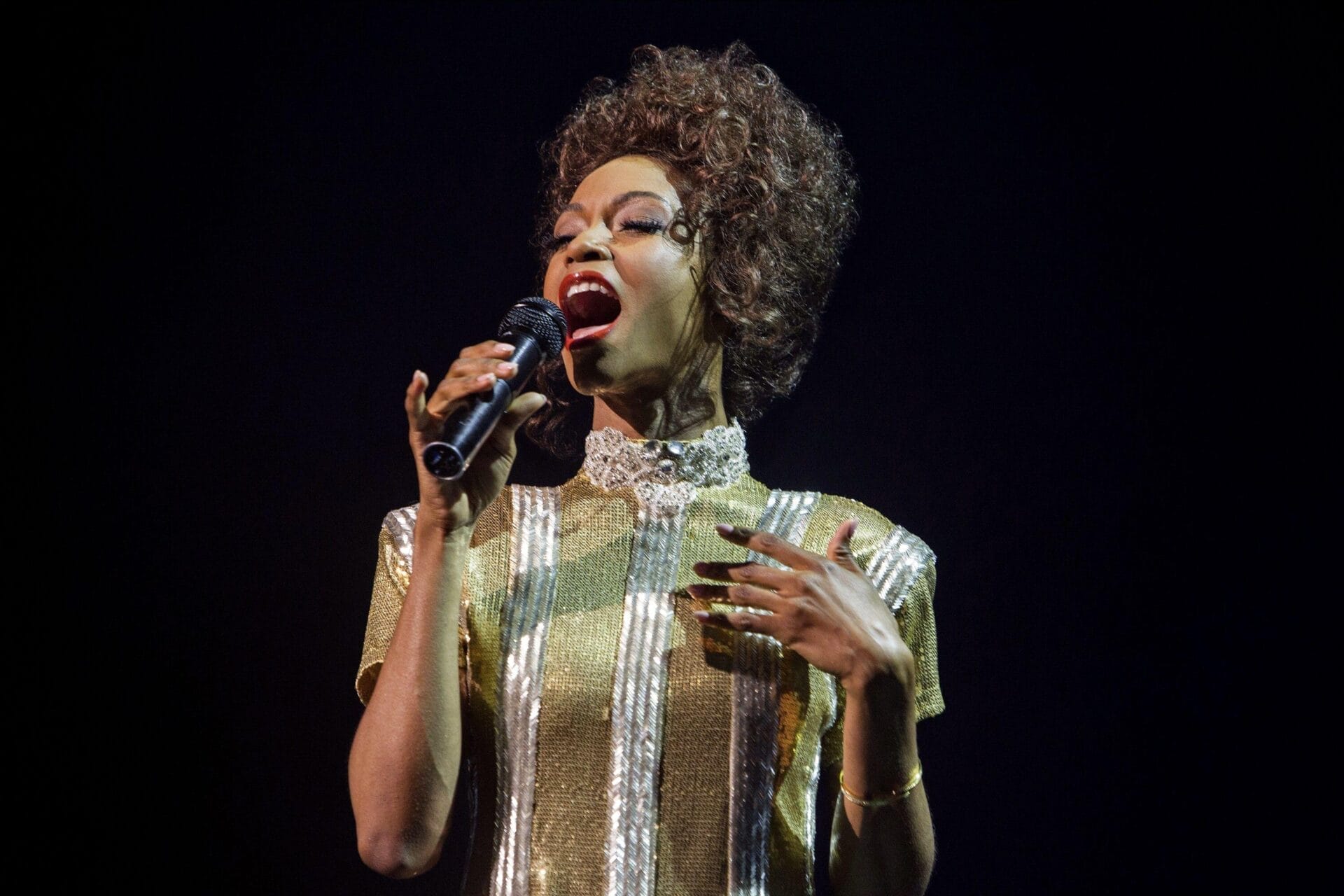 image showing Yaya Dac=Costa singing in a music concert or studio