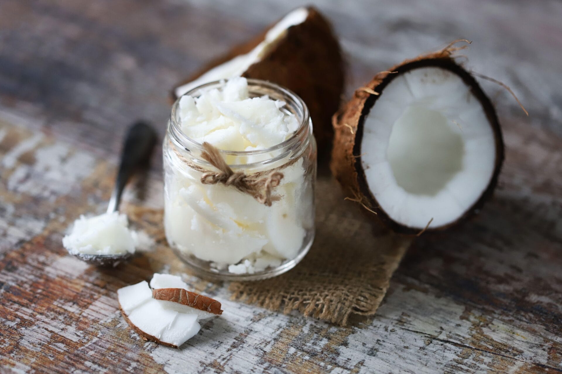 coconut being cut into two and added into a jar