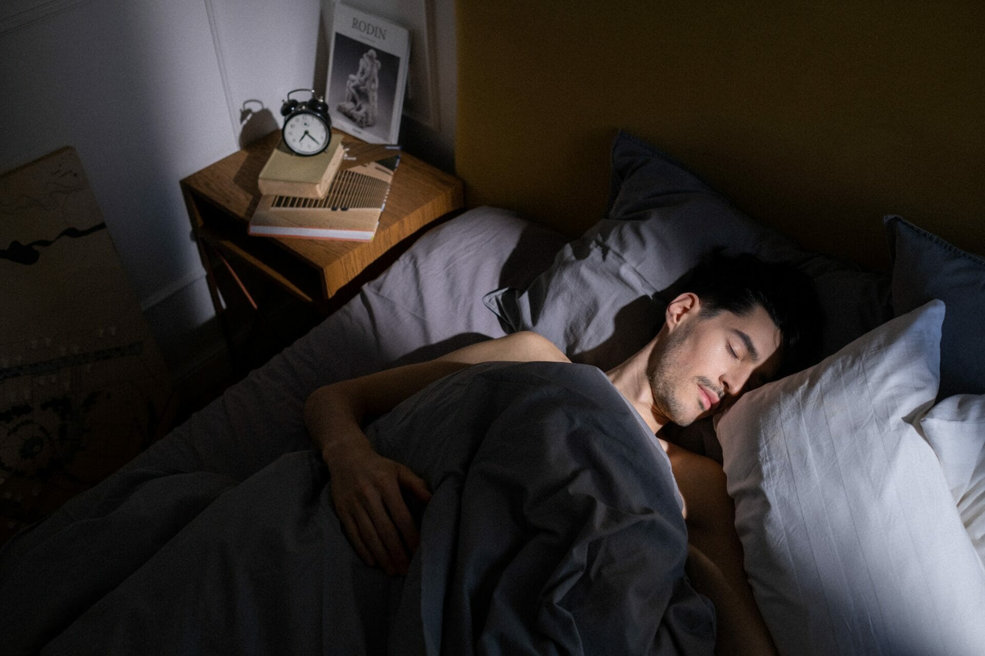 man sleeping in dark room