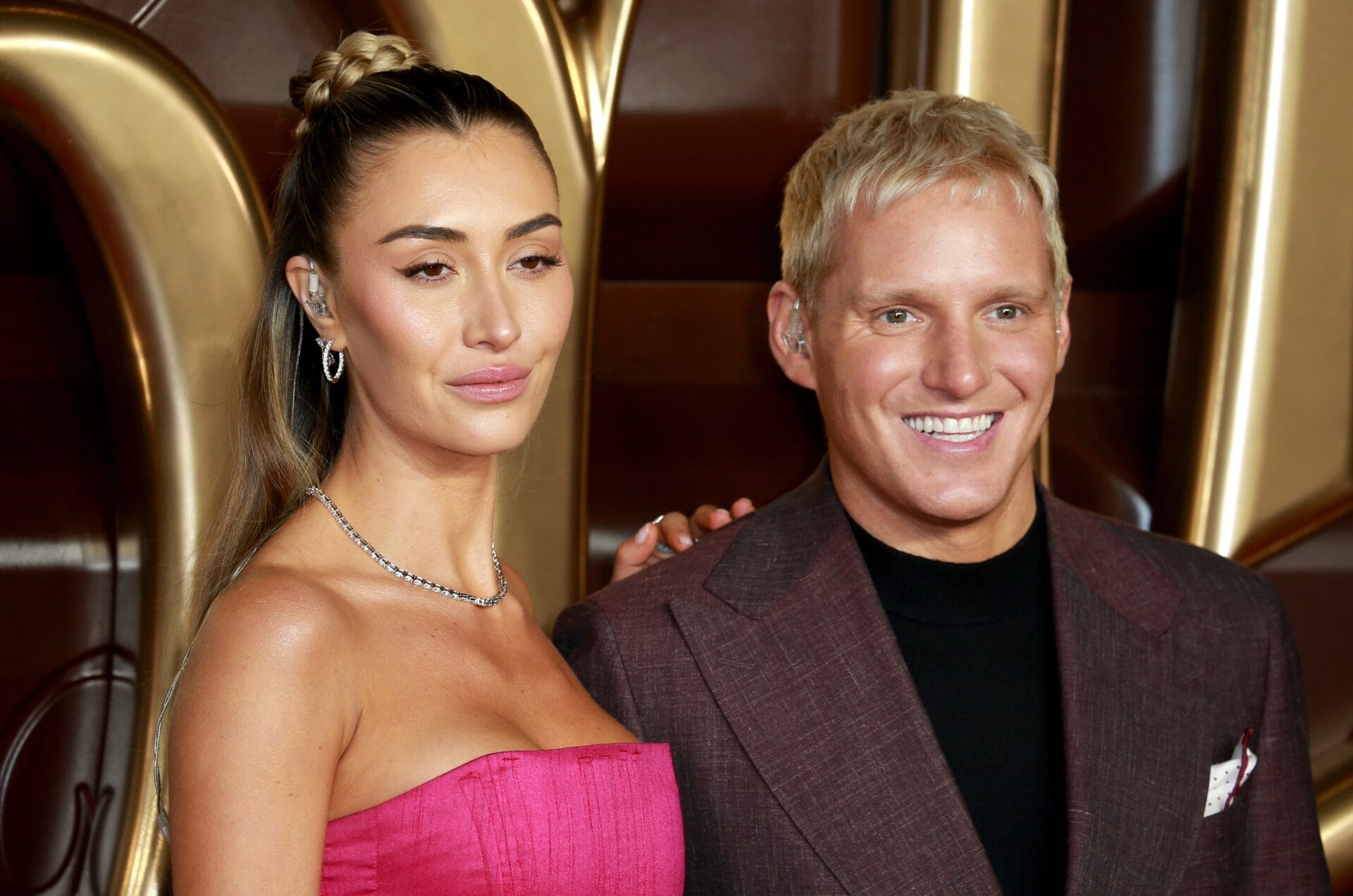 jamie laing at an event in London with his wife. Jamie wears a suit and smiling with a renewed hairline